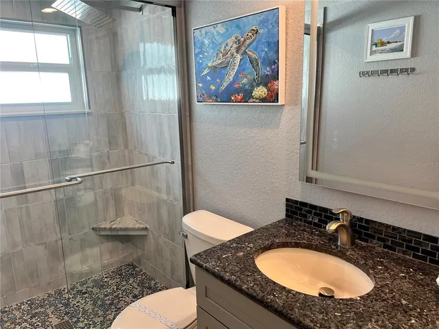 a bedroom with a bed and a night stand