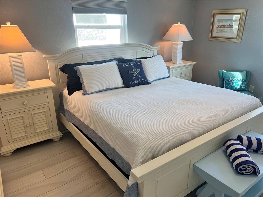 6154 Midnight Pass Road, Unit B02 Sarasota, FL 34242 - Photo 10 of 14 a bedroom with a bed and a night stand