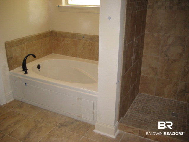 11560 Whitaker Avenue Daphne, AL 36527 - Photo 3 of 19 features separate garden tub and custom tile shower with frameless glass enclosure