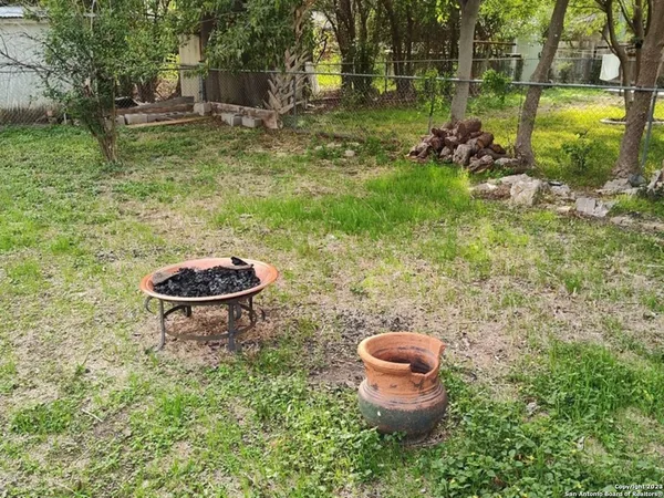 a view of a house with yard and a tree