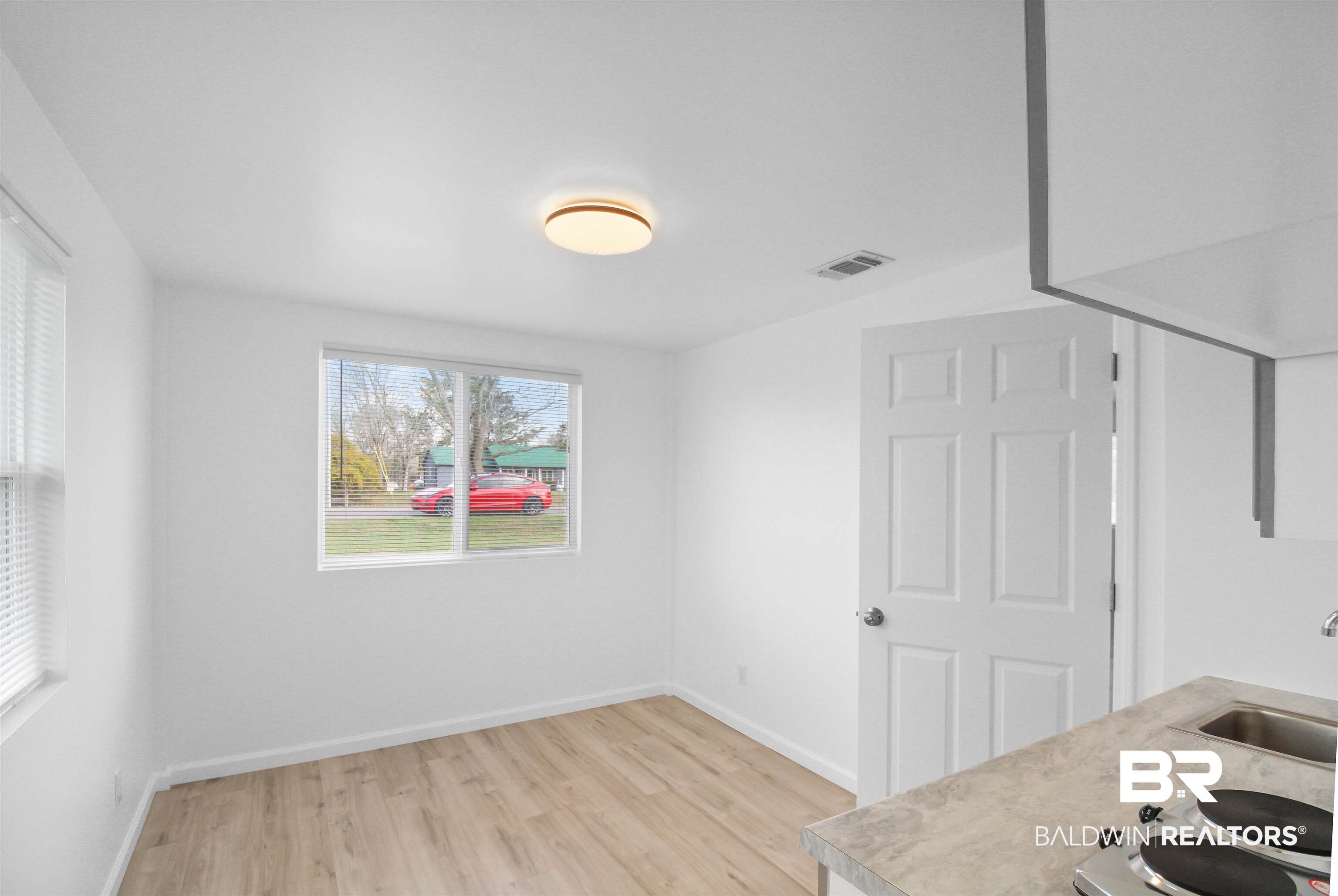 17622 Brewer Road Foley, AL 36535 - Photo 11 of 26 Unfurnished dining area featuring light wood-style floors and a sink