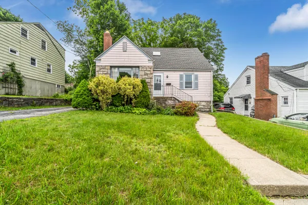 a aerial view of a house next to a big yard and large trees