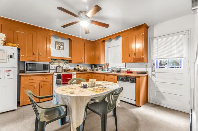 a kitchen with a sink appliances and cabinets