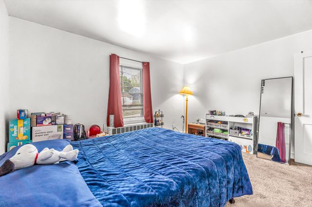 a bed sitting in a bedroom next to a window