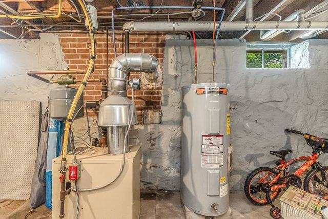 a utility room with dryer washer and other items