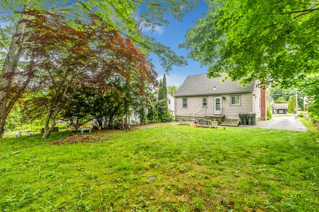 a front view of a house with yard patio and green space