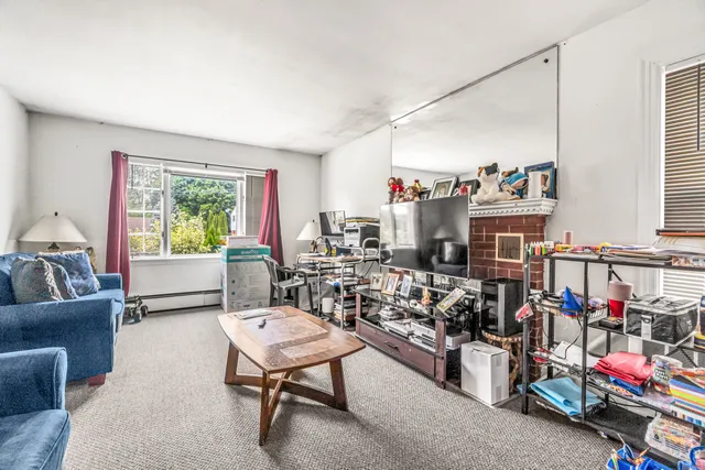 a living room with lots of furniture and a window