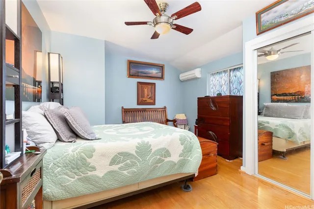 a bedroom with a bed and wooden floor