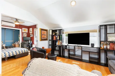 a bedroom with furniture and a flat screen tv
