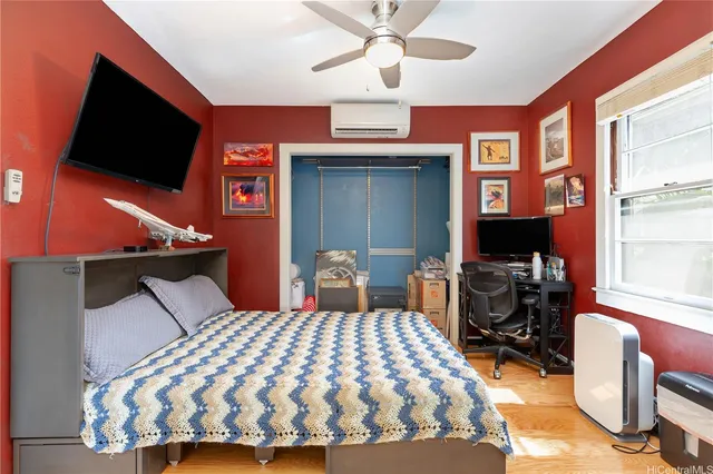a bedroom with a bed and a flat screen tv
