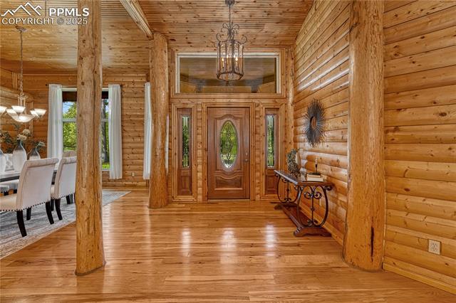 15975 Winding Trail Road Colorado Springs, CO 80908 - Photo 7 of 50 The main entry opens up to an elegantly built log home with high ceilings