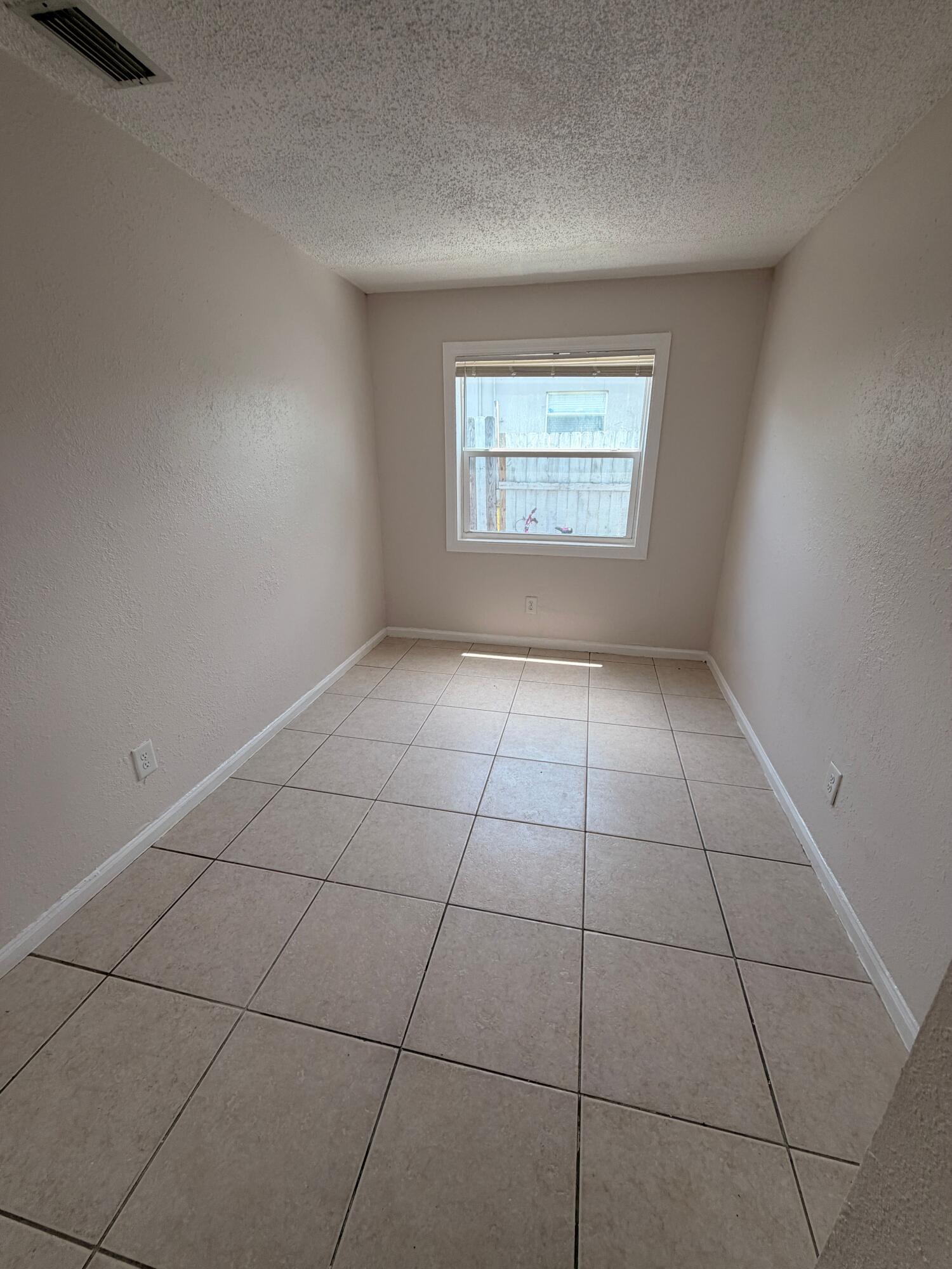1618 West 26th Court, Unit A Riviera Beach, FL 33404 - Photo 12 of 15 a view of an empty room with a window