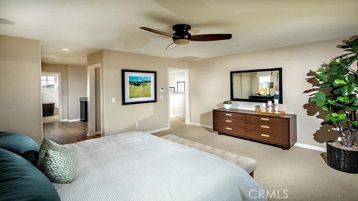 14073 Versimo Lane Beaumont, CA 92223 - Photo 15 of 20 a bedroom with a bed and a potted plant