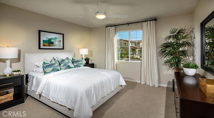 14073 Versimo Lane Beaumont, CA 92223 - Photo 20 of 20 a bedroom with bed and a potted plant