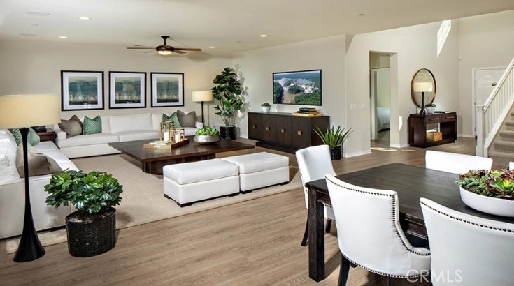 14073 Versimo Lane Beaumont, CA 92223 - Photo 6 of 20 a living room with furniture potted plant and a wooden floor