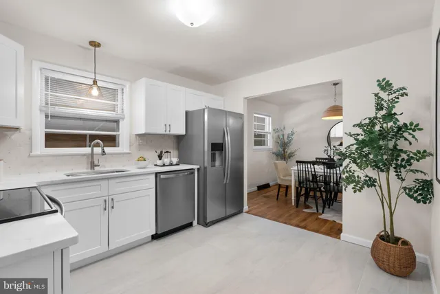 a kitchen with sink refrigerator and cabinets