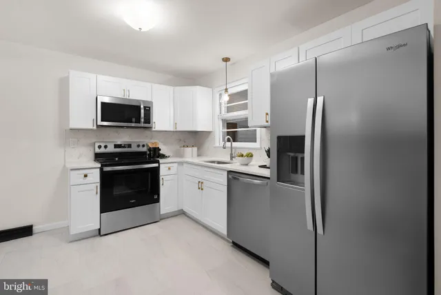 a kitchen with stainless steel appliances a refrigerator stove and microwave