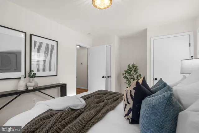 a bedroom with a bed and a potted plant