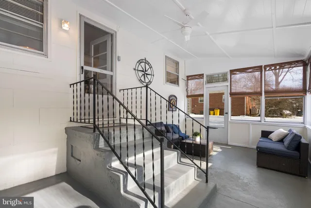a view of staircase with white walls and windows