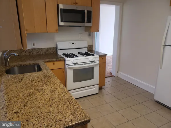 a kitchen with a stove and a sink