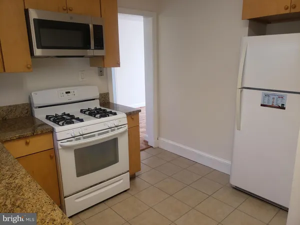a kitchen with a stove and a microwave