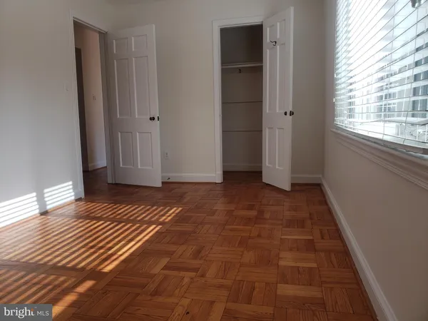a view of a room with wooden floor and window