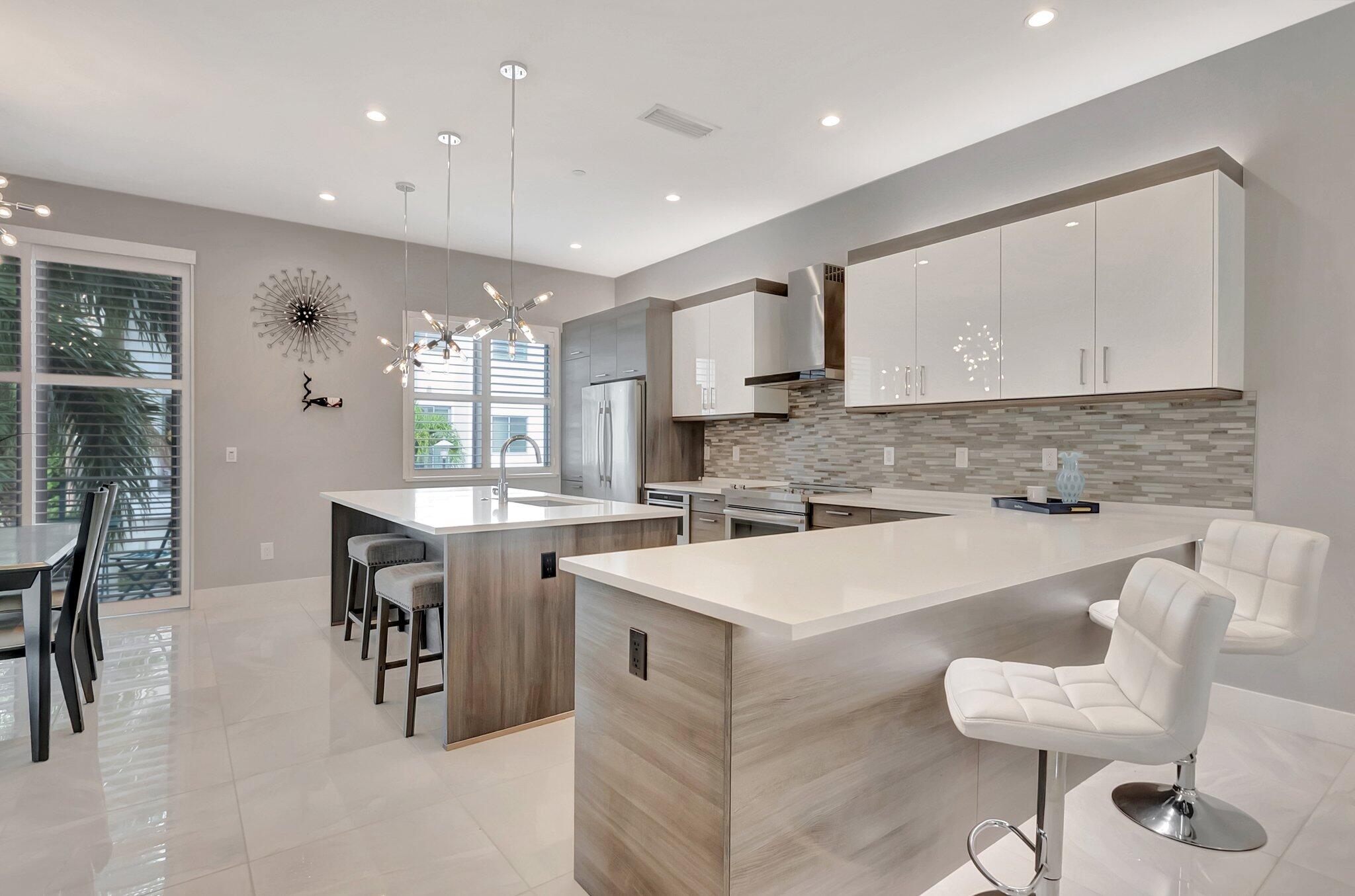 4010 Northwest 18th Way Boca Raton, FL 33431 - Photo 11 of 35 a kitchen with a sink cabinets and dining table