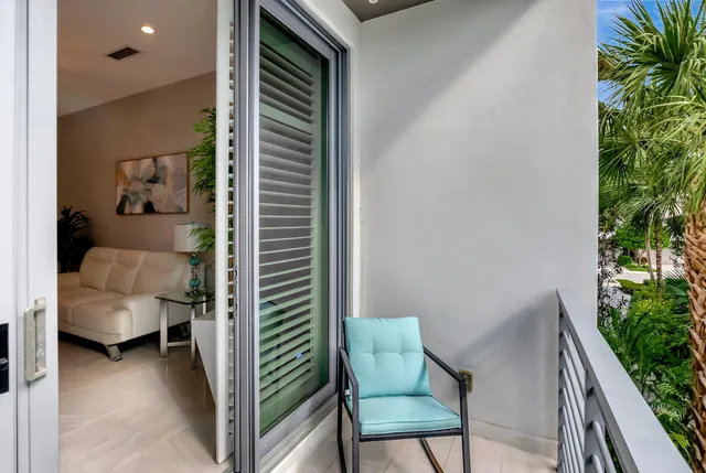 a spacious bedroom with a bed and a chandelier