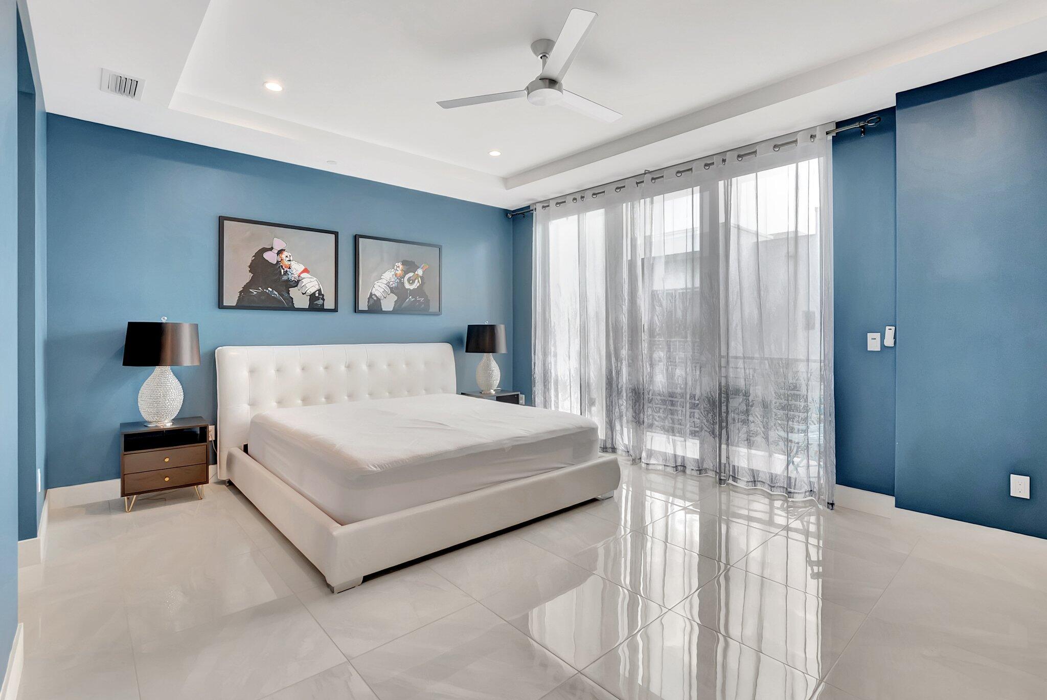 4010 Northwest 18th Way Boca Raton, FL 33431 - Photo 15 of 35 a spacious bedroom with a bed and a chandelier