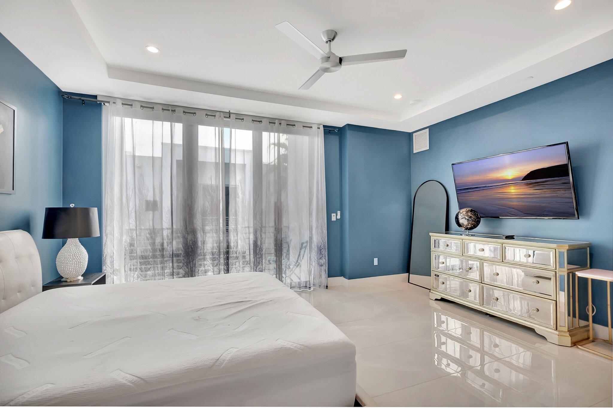 4010 Northwest 18th Way Boca Raton, FL 33431 - Photo 16 of 35 a bedroom with a bed and a flat screen tv