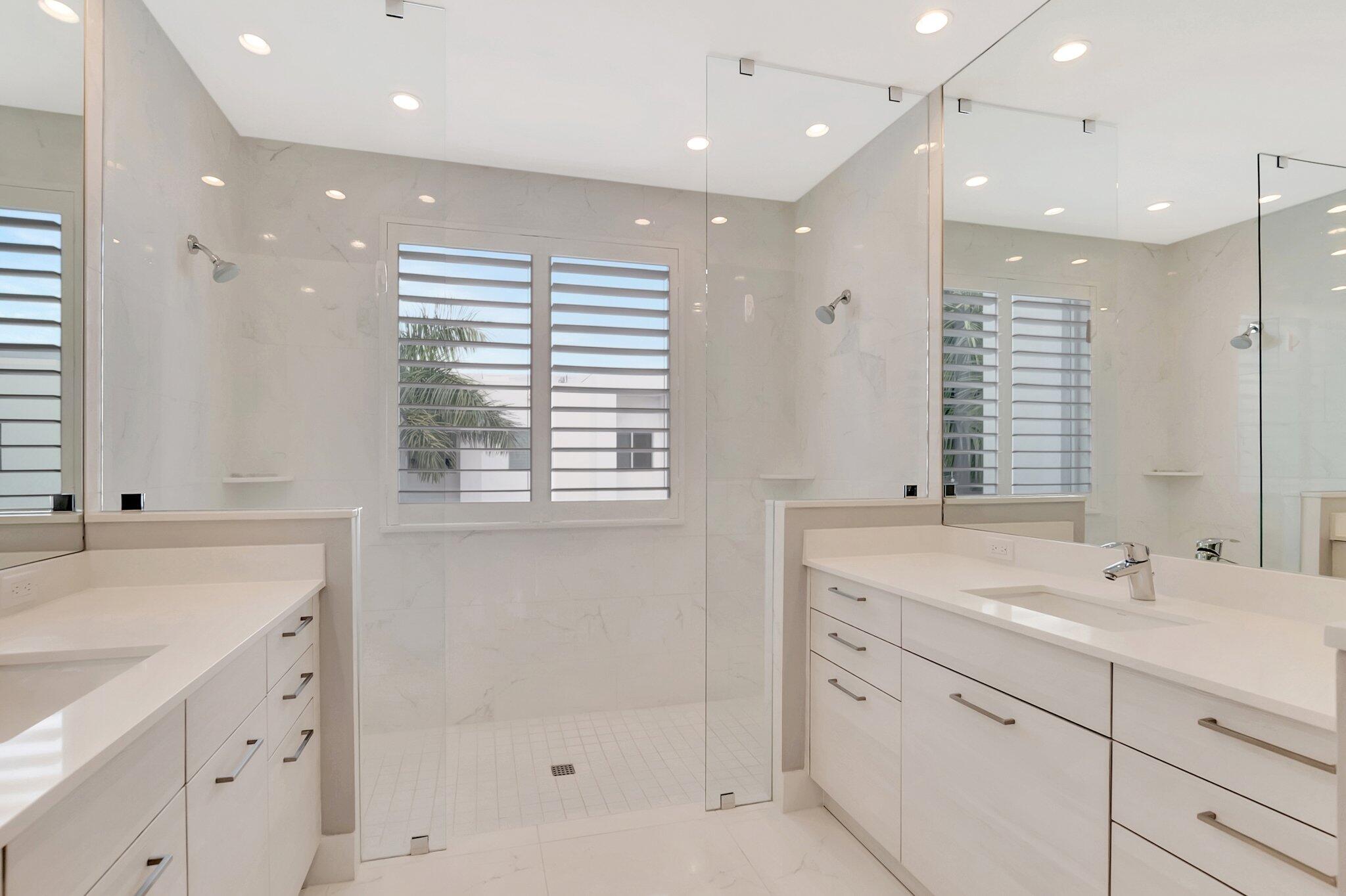 4010 Northwest 18th Way Boca Raton, FL 33431 - Photo 17 of 35 a bathroom with a double vanity sink large mirror and a bathtub