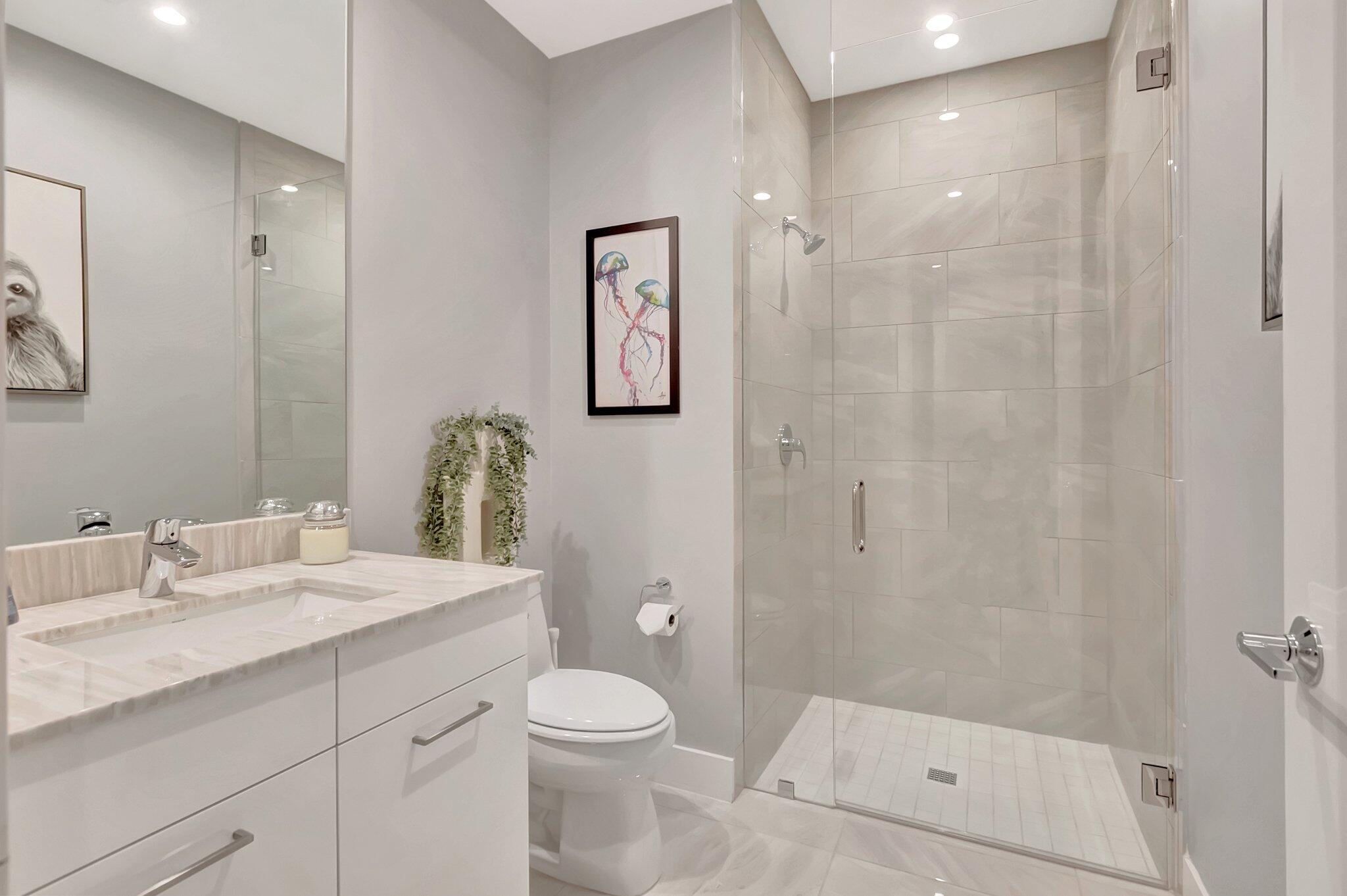 4010 Northwest 18th Way Boca Raton, FL 33431 - Photo 26 of 35 a bathroom with a granite countertop sink a toilet and shower