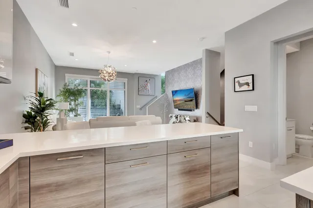 a kitchen with kitchen island a counter top space appliances and cabinets