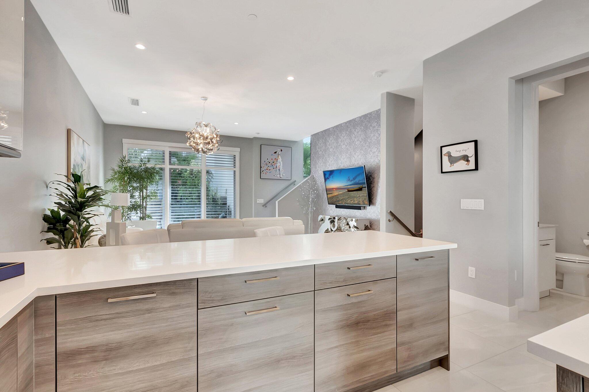 4010 Northwest 18th Way Boca Raton, FL 33431 - Photo 7 of 35 a view of cabinets a sink and a mirror