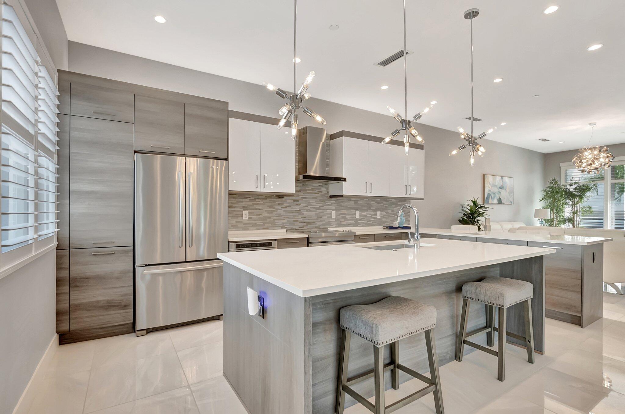 4010 Northwest 18th Way Boca Raton, FL 33431 - Photo 8 of 35 a kitchen with kitchen island a counter top space appliances and cabinets