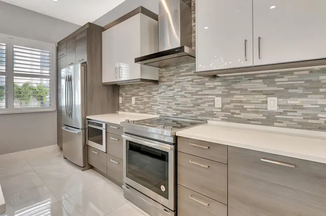 a kitchen with a sink a stove and cabinets