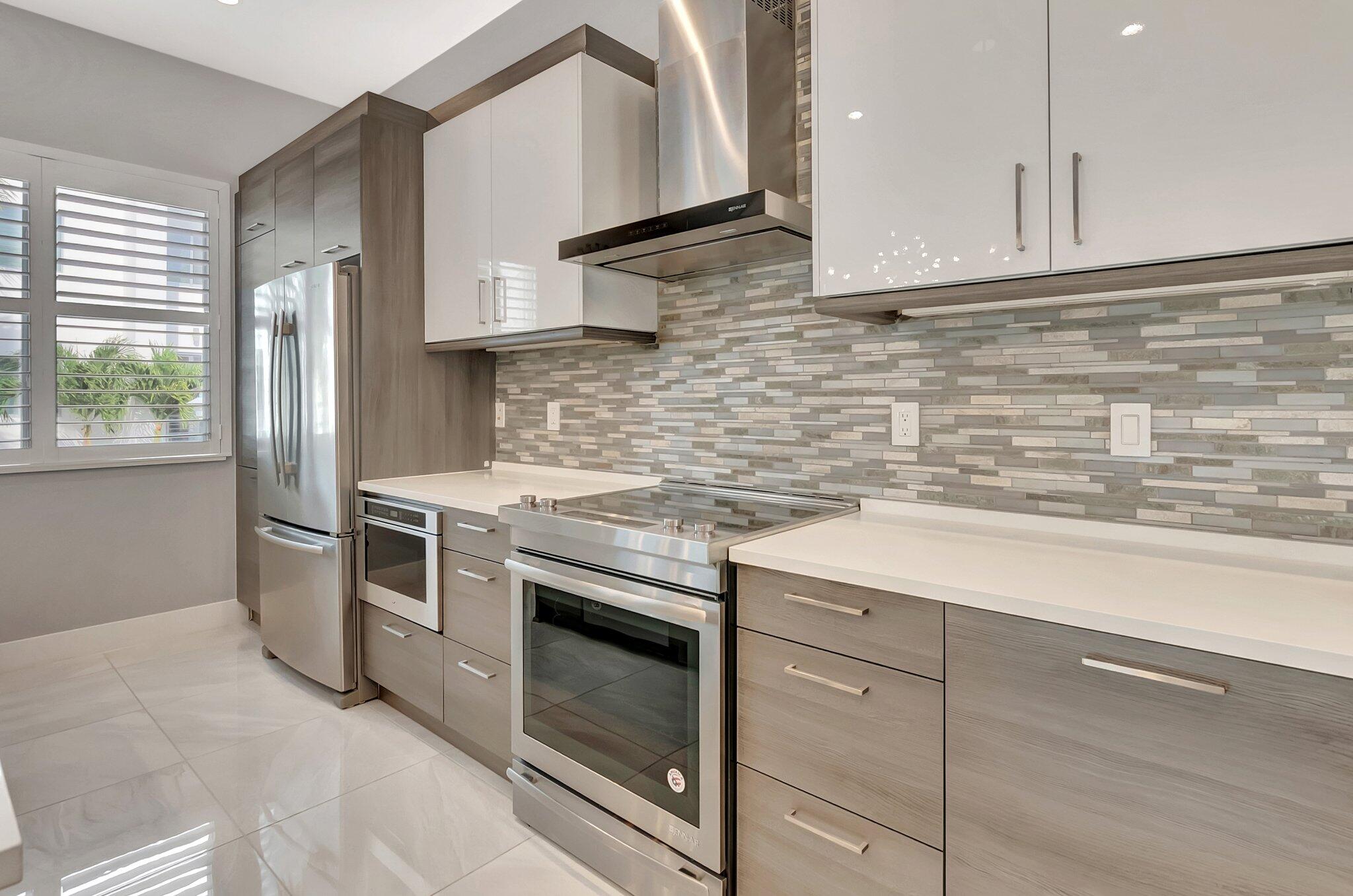 4010 Northwest 18th Way Boca Raton, FL 33431 - Photo 9 of 35 a kitchen with granite countertop cabinets stainless steel appliances and sink