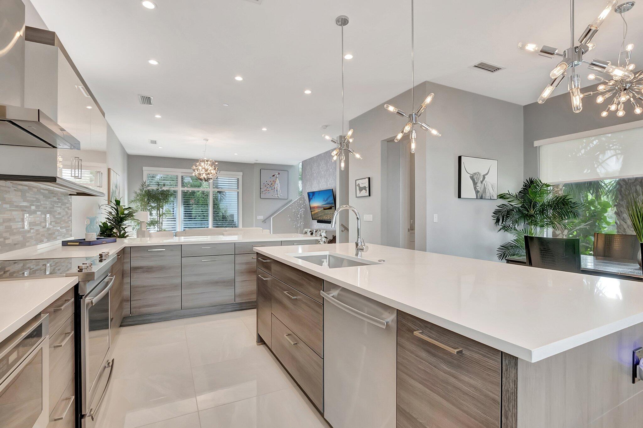 4010 Northwest 18th Way Boca Raton, FL 33431 - Photo 10 of 35 a kitchen with a sink a stove and cabinets