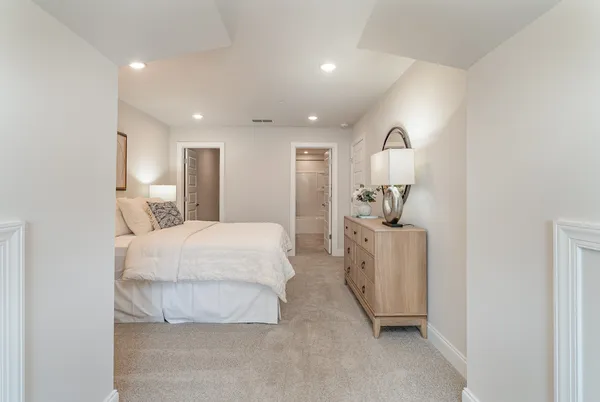 a room with a bed and a dresser