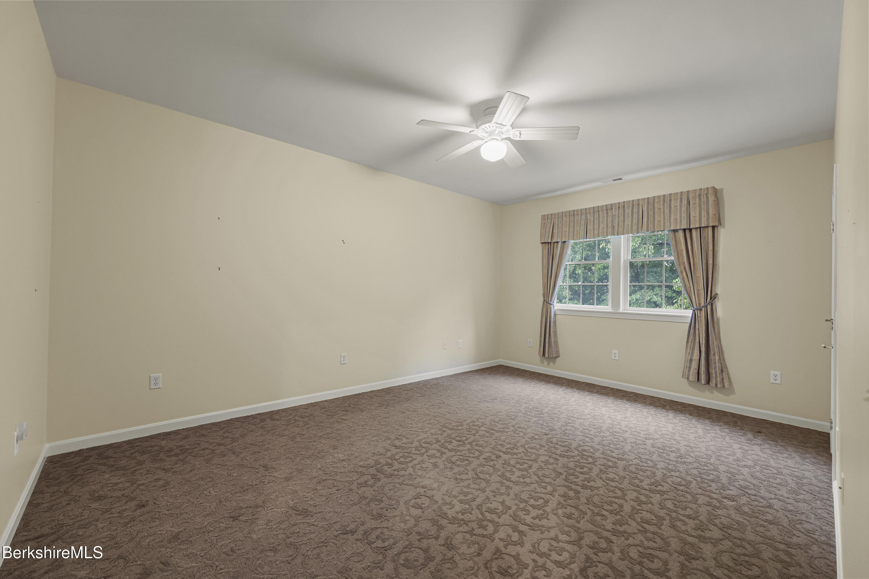2 Amy Court Pittsfield, MA 01201 - Photo 34 of 50 an empty room with a window and a fan
