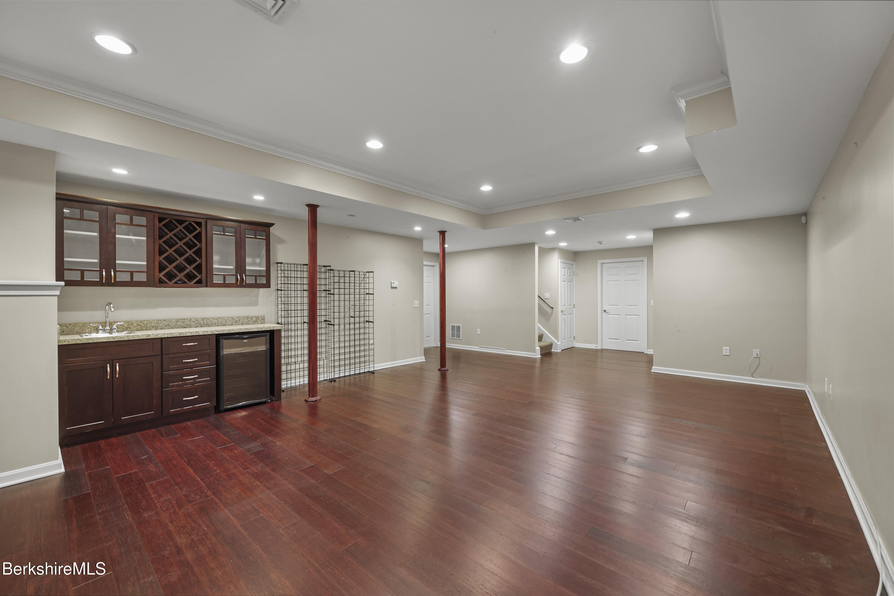 2 Amy Court Pittsfield, MA 01201 - Photo 42 of 50 a view of an empty room with wooden floor and kitchen