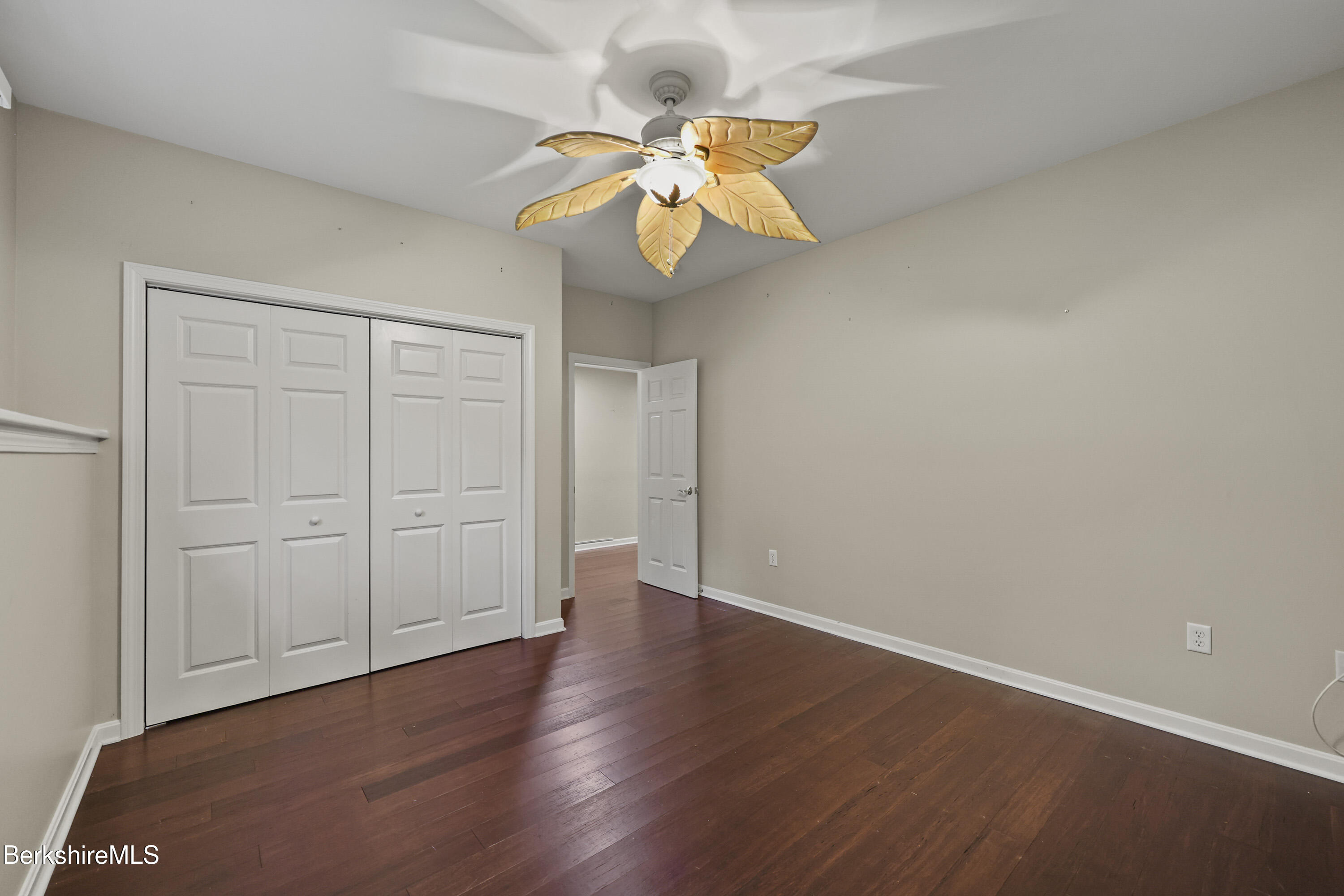 2 Amy Court Pittsfield, MA 01201 - Photo 46 of 50 a view of an empty room with a window and wooden floor