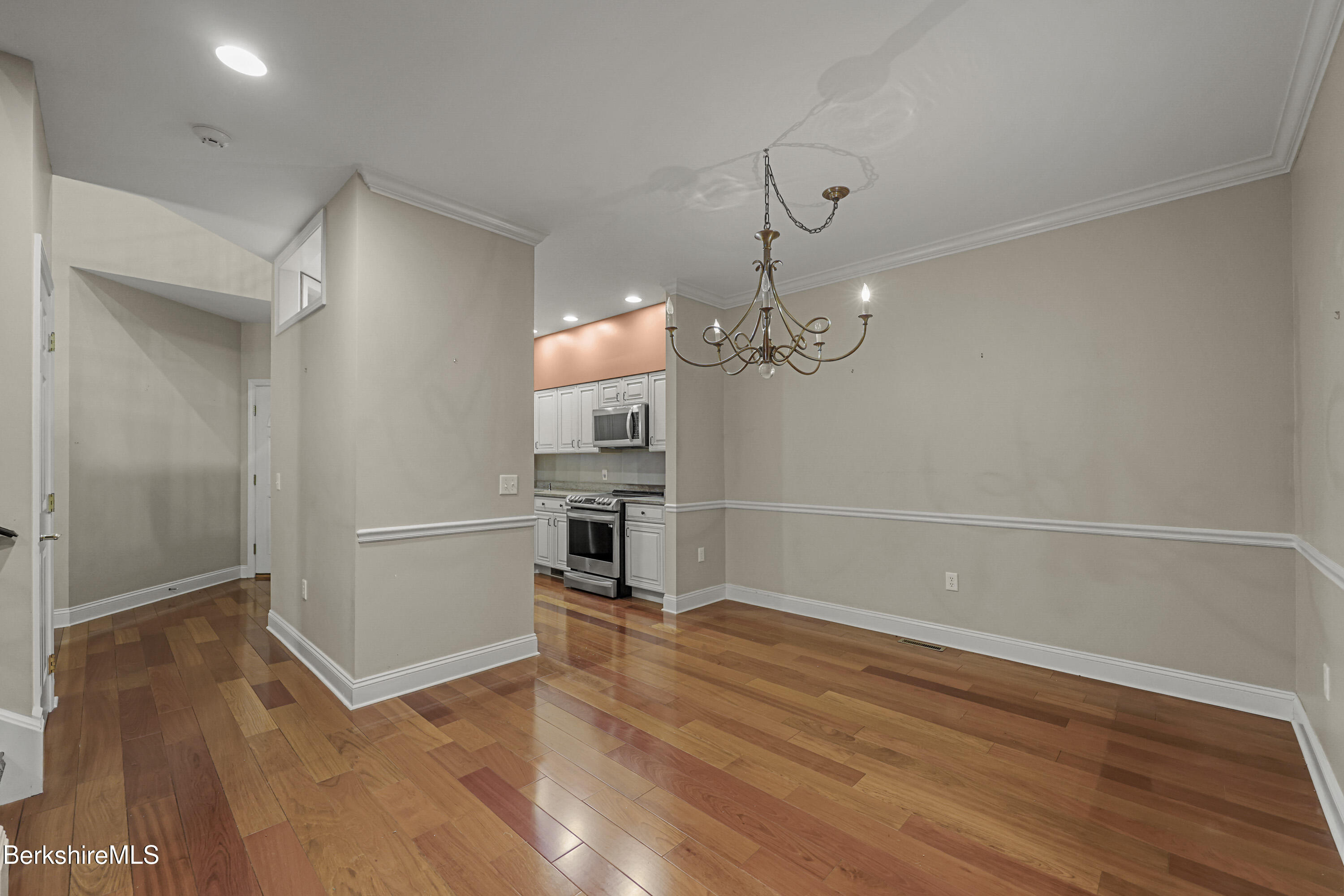2 Amy Court Pittsfield, MA 01201 - Photo 9 of 50 a view of a room with wooden floor and kitchen view