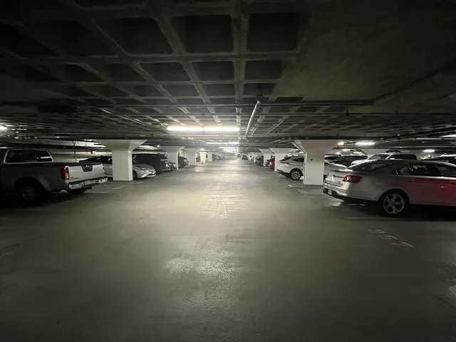 a view of parking garage with cars