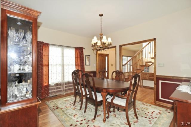 389 Winter Springs Road Nazareth, PA 18064 - Photo 13 of 37 a dining room with furniture a chandelier and wooden floor