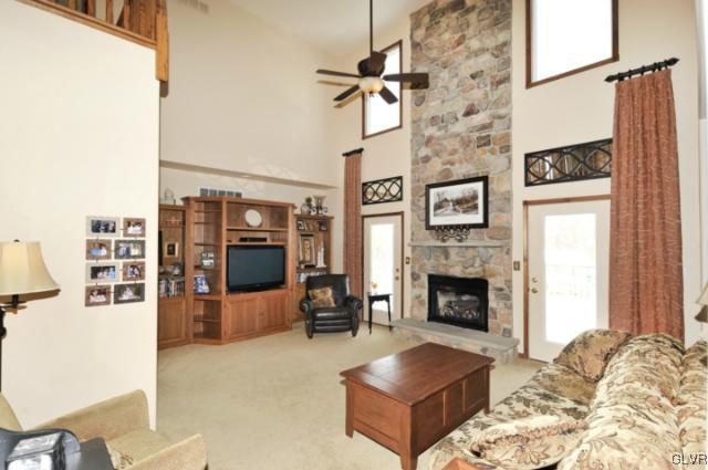 389 Winter Springs Road Nazareth, PA 18064 - Photo 15 of 37 a living room with furniture a fireplace and a flat screen tv