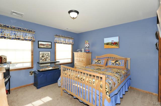389 Winter Springs Road Nazareth, PA 18064 - Photo 31 of 37 a bedroom with a bed a window and painting on the wall