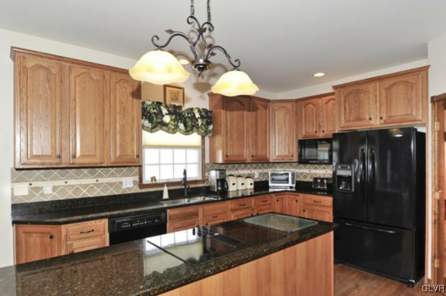 389 Winter Springs Road Nazareth, PA 18064 - Photo 5 of 37 a kitchen with stainless steel appliances granite countertop a sink a refrigerator and a granite counter tops