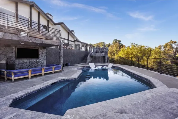 a view of a patio with a table and chairs under an umbrella