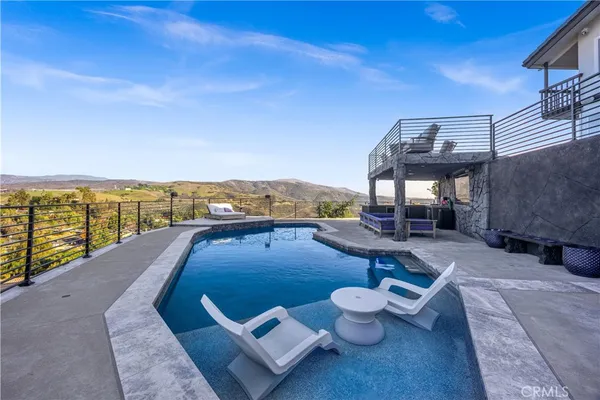 a view of a backyard with chairs